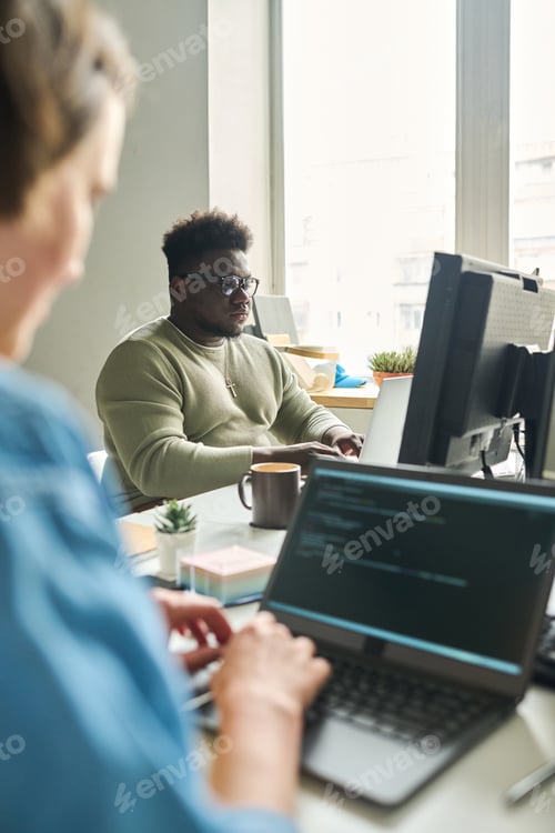 Preview: African man working on computer at office