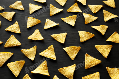 Preview: Corn Tortilla Chips on a black background, side view.