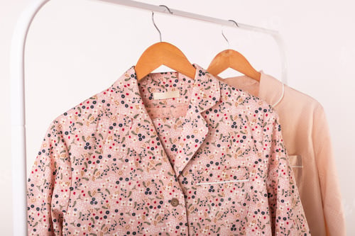Preview: Clothing retails concept. Ladies pajamas on hangers in clothes store. Pajama in shop. Advertise