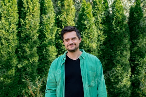 Preview: Smiling man in green shirt at outdoors