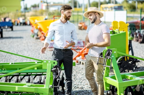 Preview: Agronomist with salesman at the shop with agricultural machinery