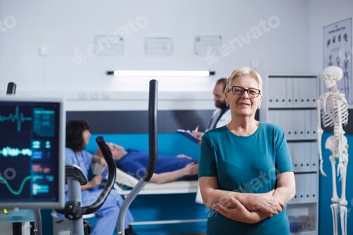Preview: Retired woman looks at camera in clinic