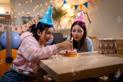 Preview: Two Asian women in room with Ciematic lighting celebrate important events such birthdays Christmas
