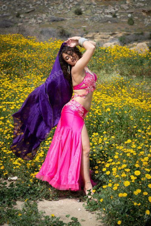 Preview: Woman performing belly oriental dancing wearing coloured costume. Outdoors dancing