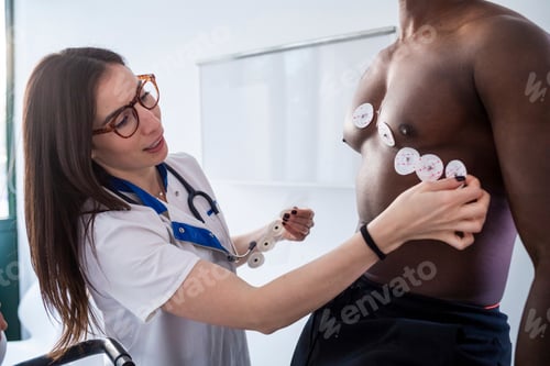Preview: Nurse performing ECG test on patient in consultation room