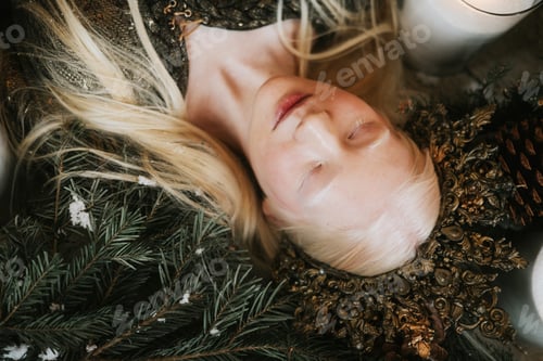 Preview: young albino woman with blue eyes and long white hair in beautiful green dress and crown lying on fl