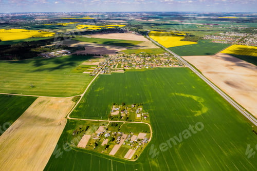 Preview: top view of a sown green field and a small village in Belarus. Agricultural fields in the village