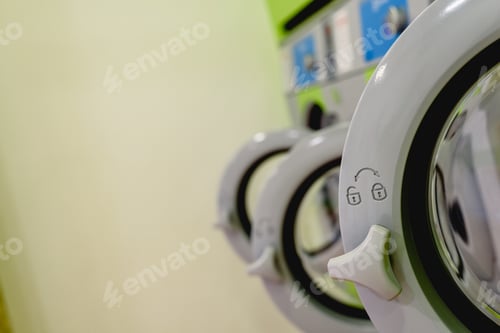 Preview: Open doors of industrial washing machines in a public laundry, door lock padlock