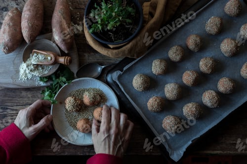 Preview: Person rolling in breadcrumbs sweet potatoes