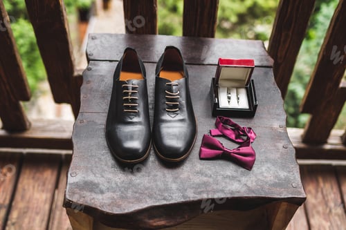 Preview: Man wedding set, leather shoes, rings in box and bow tie on wooden texture