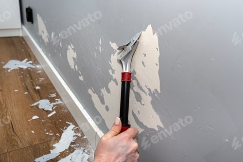 Preview: Removing silicone paint from a wall damaged by dog claws using a paint and adhesives scraper.