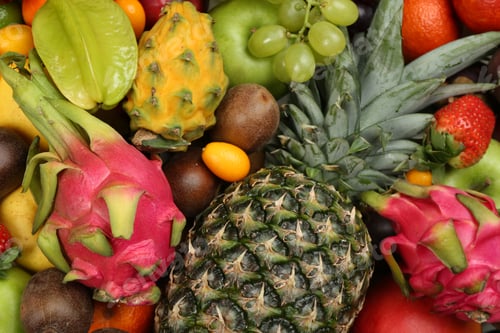 Preview: Assortment of fresh exotic fruits as background, top view