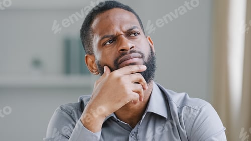 Preview: Pensive ethnic bearded African American man thinking businessman searching solution of difficult