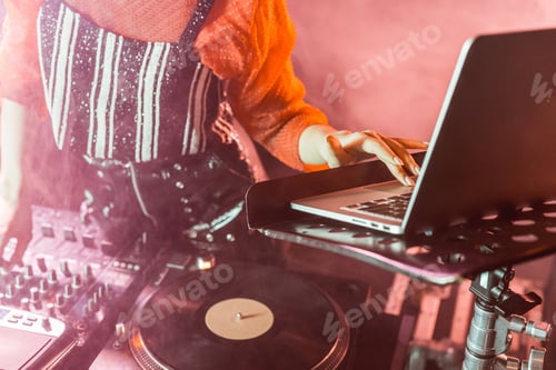 Preview: cropped view of dj girl using laptop in nightclub with smoke