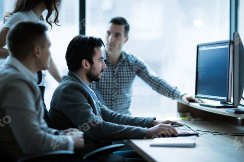 Preview: Coworkers working on project together in office