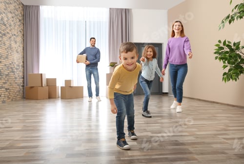 Preview: Happy family and pile of moving boxes in their new house