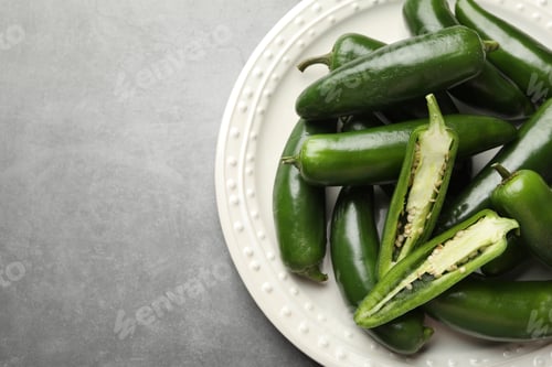 Preview: Ripe green jalapeno peppers on grey table, top view. Space for text