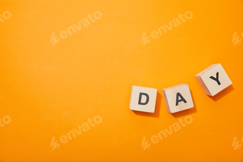 Preview: top view of wooden blocks with letters on orange surface
