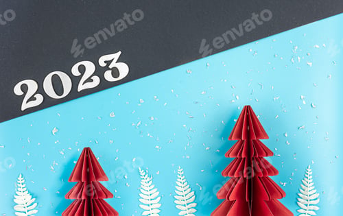 Preview: Christmas background with origami paper tree and number 2023, flat lay.
