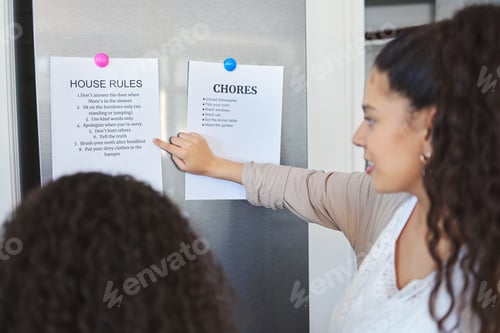 Preview: Your new dos and donts. Shot of a mother explaining a list of chores to her daughter at home.