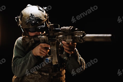 Preview: US special forces soldier looking at the aim ready to shoot against black dark background