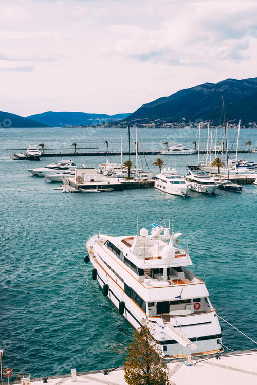 Preview: Double-decked white yacht is moored to the pier. Porto, Montenegro