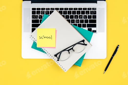 Preview: Laptop and notebooks on a yellow background, top view.