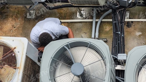 Preview: HVAC technician millennial is Latino working to maintain high efficiency heating and cool at beach.