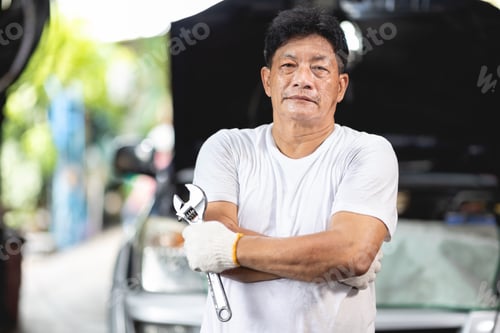 Preview: Asian male mechanic professional portrait happy smile work man in garage auto service