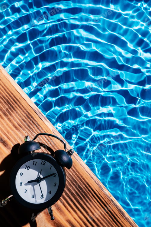 Preview: Wood board black alarm daily clock. Blue transparent reflect wave water surface ocean.