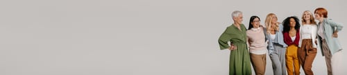Preview: Multi-ethnic group of confident mature women embracing and smiling against grey background