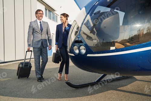 Preview: Entrepreneurs with their luggage walking towards chopper