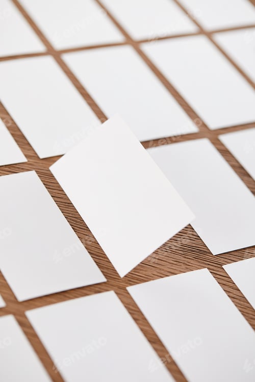 Preview: selective focus of set of empty business cards at wooden table