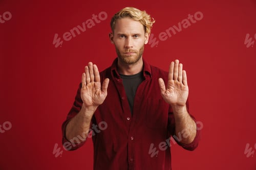 Preview: White bearded man wearing shirt showing stop gesture at camera