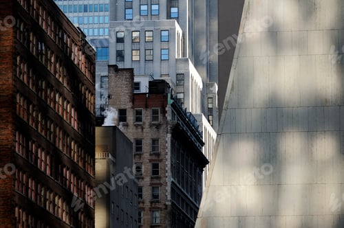 Preview: Buildings in New York City, view from below, historic and modern architecture, shadows and sunlight