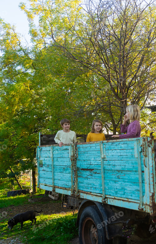 Preview: Children riding a car in the field