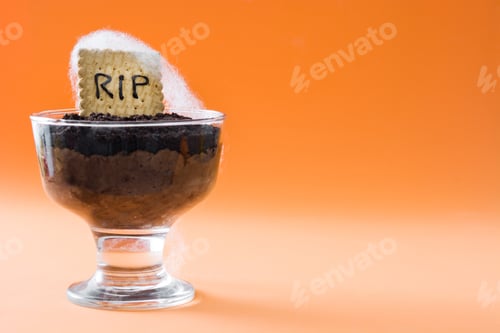Preview: Halloween chocolate dessert presenting tombstone cookie with rip lettering and cobwebs