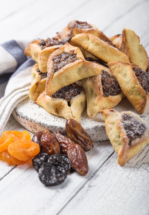 Preview: Traditional Jewish Hamantaschen cookies with dried apricots, dates. Purim celebration concept.