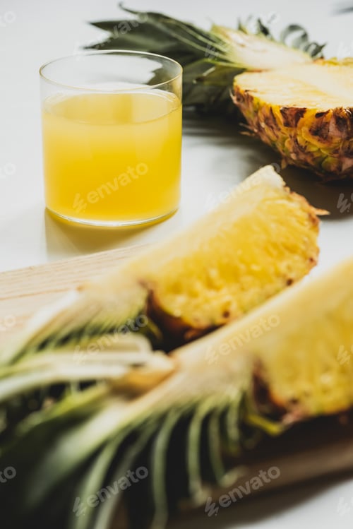 Preview: Fresh Pineapple Juice Near Cut Delicious Fruit on Cutting Board on White Background