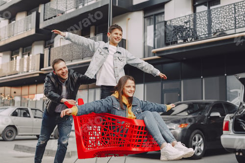 Preview: Cute family playing with a carts in a city