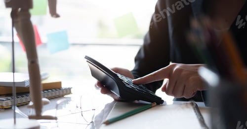 Preview: Businesswoman working about calculating budget income stats using calculator holding a pen pointing
