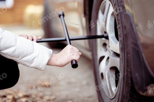 Preview: Closeup shot of a mechanic trying to fix a car with special tools
