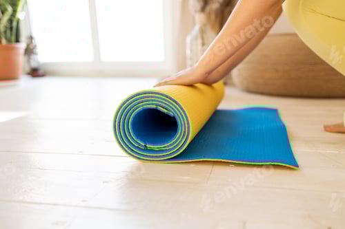 Preview: Rolling Up a Blue and Yellow Yoga Mat