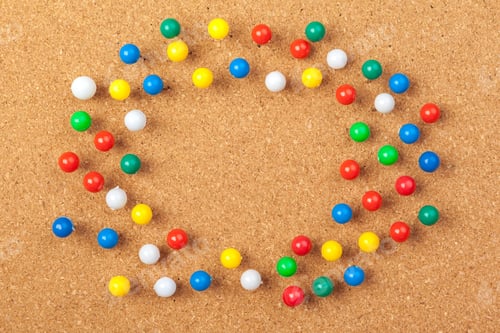 Preview: Group of thumbtacks pinned on corkboard. Close up