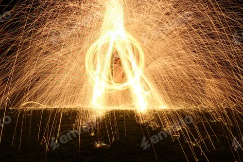 Preview: Closeup shot of a man making sparks in the night