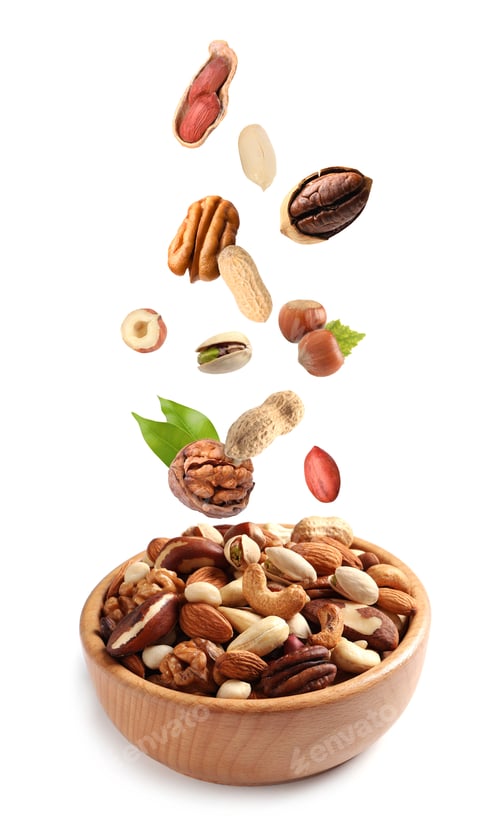 Preview: Different nuts falling into bowl on white background