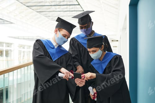 Preview: Group of graduates using smartphone