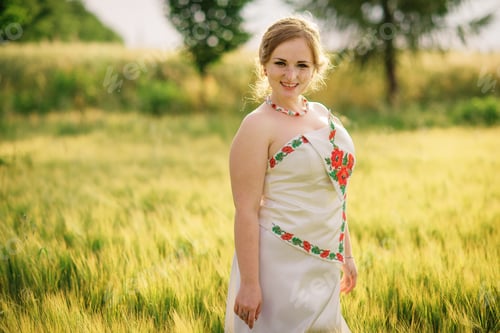 Preview: Young girl at ukrainian national dress posed at wreath field.