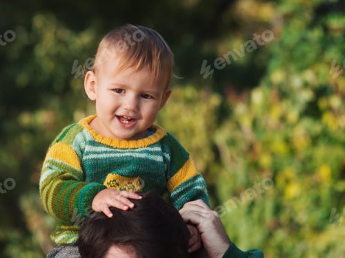 Preview: Cute small baby boy in autumn park with his dad