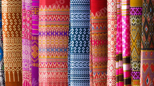 Preview: Row of hanging multicolored cotton sarong clothing for sale on street market at Thailand